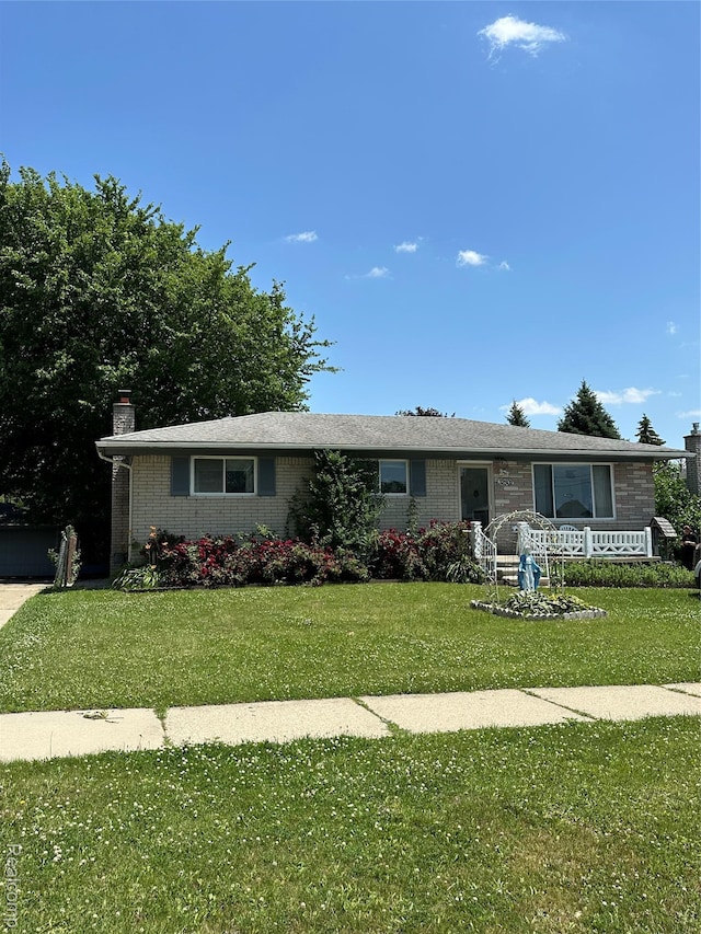 32302 Ryan Rd, Warren, MI 48092 - ranch-style house featuring brick siding, a front yard, and a chimney