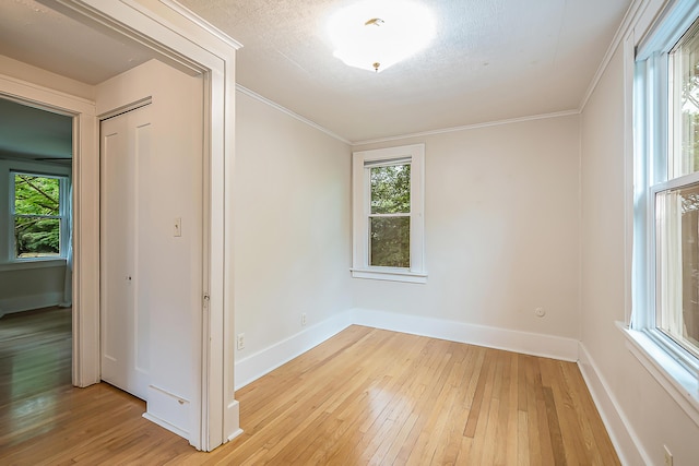 324 Highlake Ave, Ann Arbor, MI 48103 - empty room featuring light wood finished floors, healthy amount of natural light, and crown molding