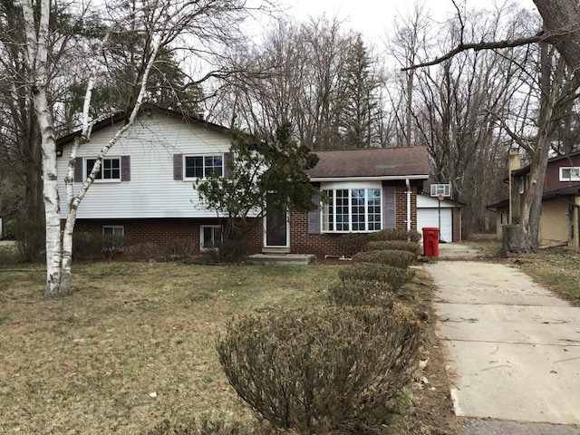 20072 Woodburn, Southfield, MI 48075 - split level home with brick siding, a front lawn, and a garage