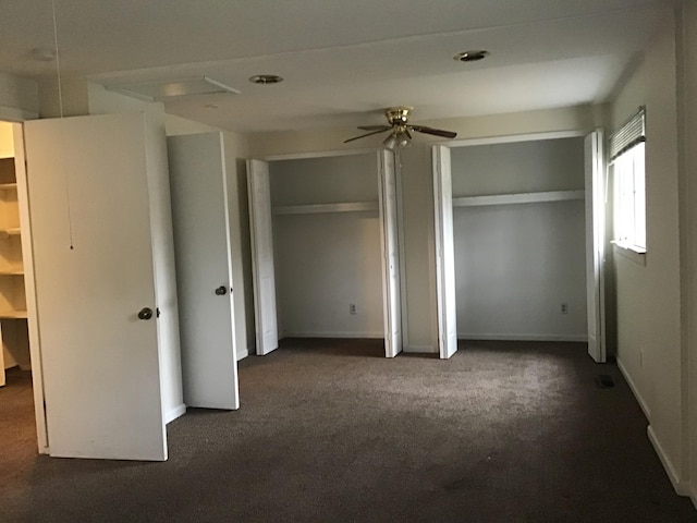 20072 Woodburn, Southfield, MI 48075 - unfurnished bedroom featuring two closets and dark colored carpet