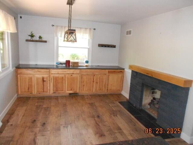 1090 Cadet Ln, Kalamazoo, MI 49009 - unfurnished dining area with wood finished floors and a fireplace with flush hearth