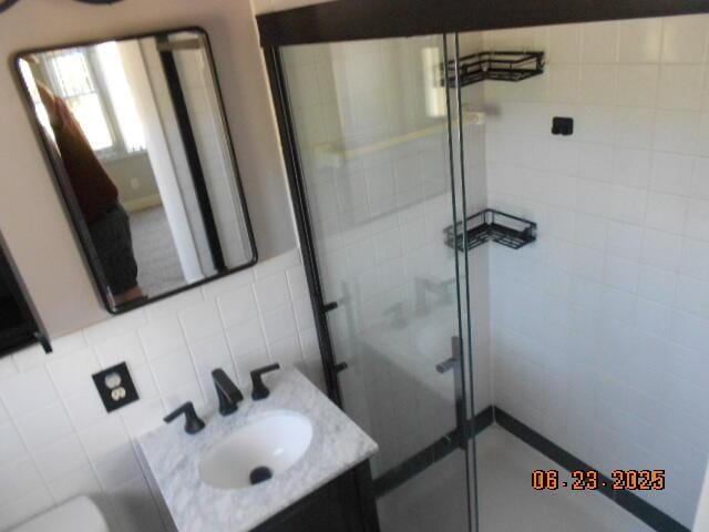 1090 Cadet Ln, Kalamazoo, MI 49009 - full bath featuring vanity, a shower stall, and tile walls