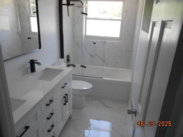 1090 Cadet Ln, Kalamazoo, MI 49009 - full bathroom featuring double vanity, healthy amount of natural light, marble finish flooring, and a combined bath / shower with marble appearance
