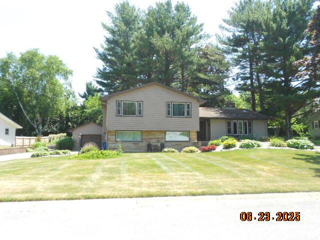 1090 Cadet Ln, Kalamazoo, MI 49009 - split level home with a detached garage and a front yard