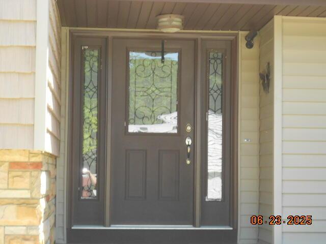1090 Cadet Ln, Kalamazoo, MI 49009 - doorway to property featuring covered porch