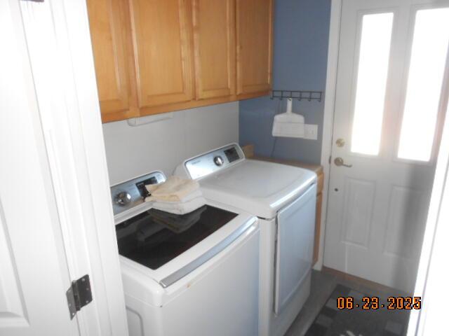 1090 Cadet Ln, Kalamazoo, MI 49009 - washroom with independent washer and dryer and cabinet space
