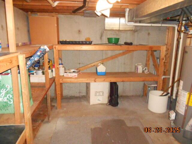 1090 Cadet Ln, Kalamazoo, MI 49009 - unfinished below grade area with gas water heater and a workshop area
