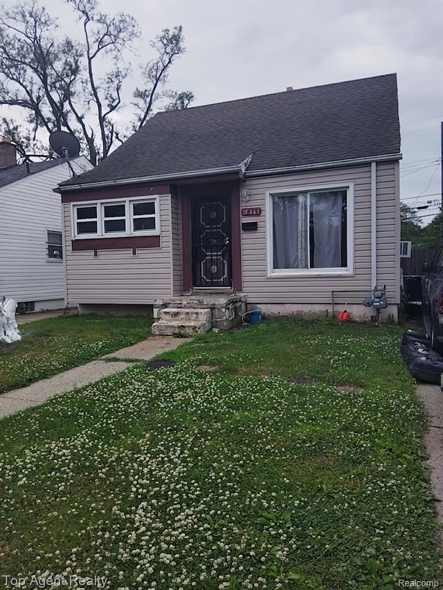 19461 Fenmore St, Redford, MI 48235 - view of front facade with a front yard and a shingled roof