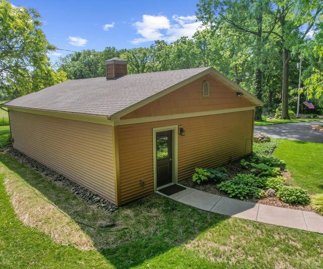 928 Curtis Rd, Quincy, MI 49082 - view of front facade featuring roof with shingles, a chimney, and a front lawn