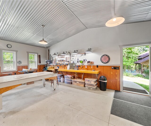 928 Curtis Rd, Quincy, MI 49082 - garage featuring a workshop area, wainscoting, and wooden walls