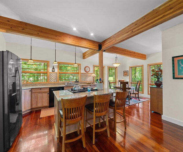 928 Curtis Rd, Quincy, MI 49082 - dining space featuring recessed lighting, beam ceiling, dark wood-type flooring, and healthy amount of natural light