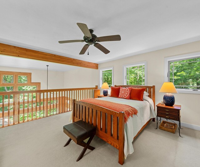928 Curtis Rd, Quincy, MI 49082 - carpeted bedroom featuring multiple windows, beam ceiling, and a ceiling fan