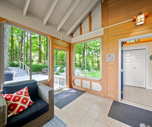 928 Curtis Rd, Quincy, MI 49082 - doorway to outside featuring tile patterned flooring and wood walls