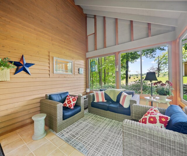 928 Curtis Rd, Quincy, MI 49082 - living area featuring tile patterned flooring, wood walls, beam ceiling, and high vaulted ceiling