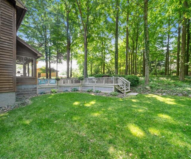 928 Curtis Rd, Quincy, MI 49082 - view of green lawn with a deck and a sunroom