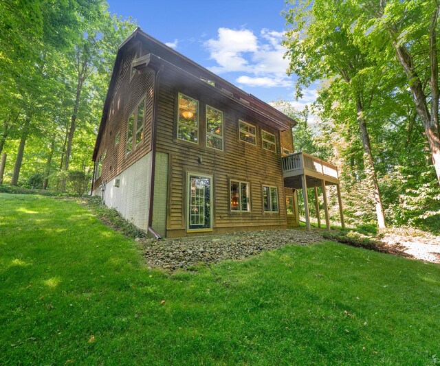 928 Curtis Rd, Quincy, MI 49082 - back of house with a yard, a deck, and brick siding