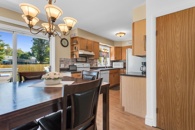 2606 S Saint Anthony St, Jackson, MI 49203 - dining area featuring a chandelier and light wood finished floors