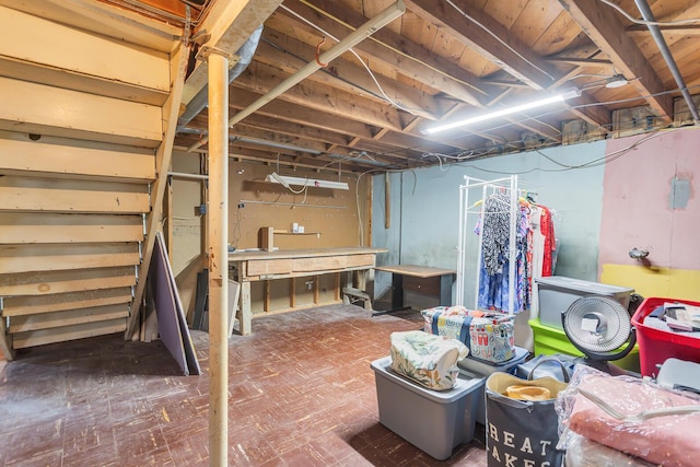 2606 S Saint Anthony St, Jackson, MI 49203 - unfinished below grade area featuring tile patterned floors and stairs