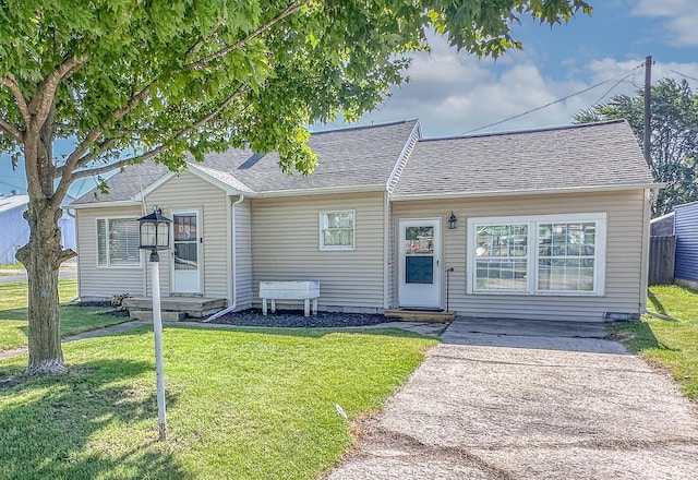 148 N Eddy St, Merrill, MI 48637 - view of front of property with a front lawn and roof with shingles