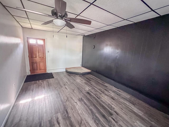 148 N Eddy St, Merrill, MI 48637 - unfurnished room with wood finished floors, a ceiling fan, and a paneled ceiling