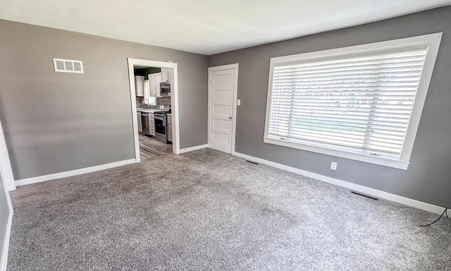 148 N Eddy St, Merrill, MI 48637 - spare room featuring carpet floors and baseboards