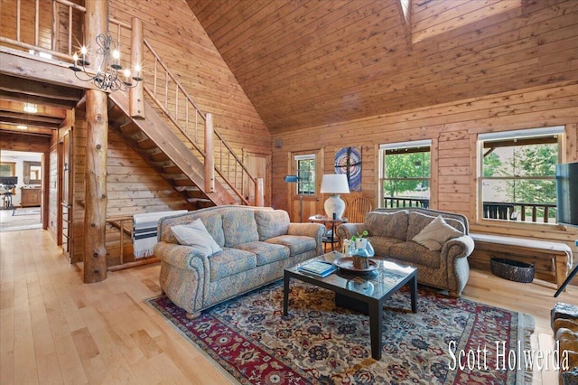 6311 142nd Ave, Holland, MI 49423 - living room with wood walls, a chandelier, high vaulted ceiling, stairs, and hardwood / wood-style floors