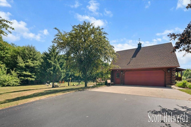 6311 142nd Ave, Holland, MI 49423 - view of front facade with driveway, an attached garage, a chimney, log exterior, and roof with shingles