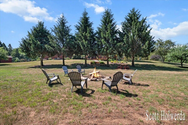 6311 142nd Ave, Holland, MI 49423 - view of grassy yard with an outdoor fire pit and view of scattered trees