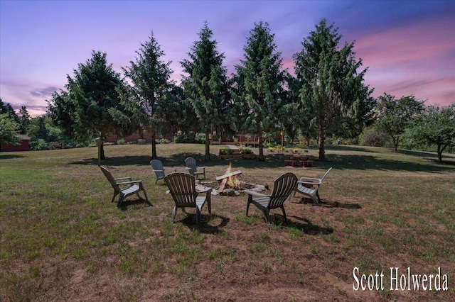 6311 142nd Ave, Holland, MI 49423 - view of green lawn with an outdoor fire pit and view of wooded area