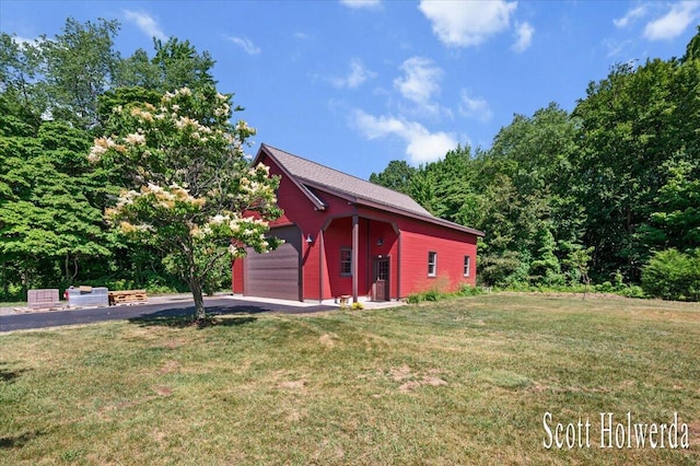6311 142nd Ave, Holland, MI 49423 - view of front of property featuring asphalt driveway, a front yard, and a garage
