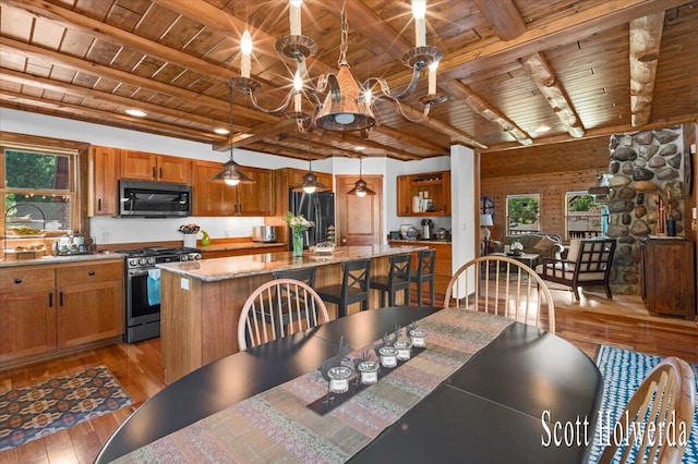 6311 142nd Ave, Holland, MI 49423 - dining room featuring a wood ceiling with exposed beams, light wood-style flooring, and a chandelier