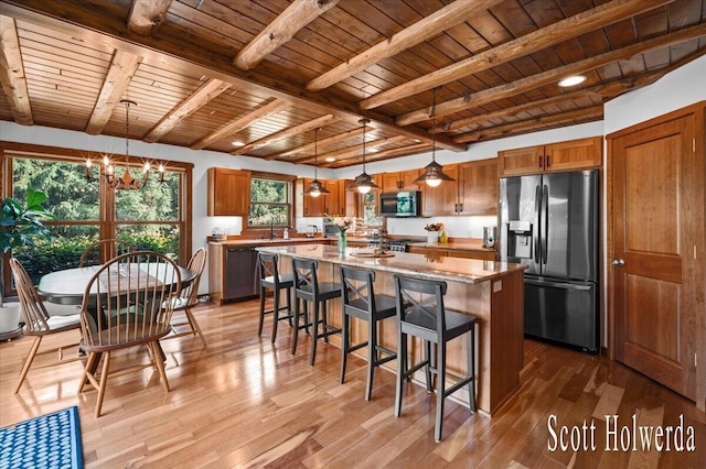6311 142nd Ave, Holland, MI 49423 - kitchen with stainless steel appliances, a wood ceiling with exposed beams, brown cabinets, a chandelier, and light wood finished floors