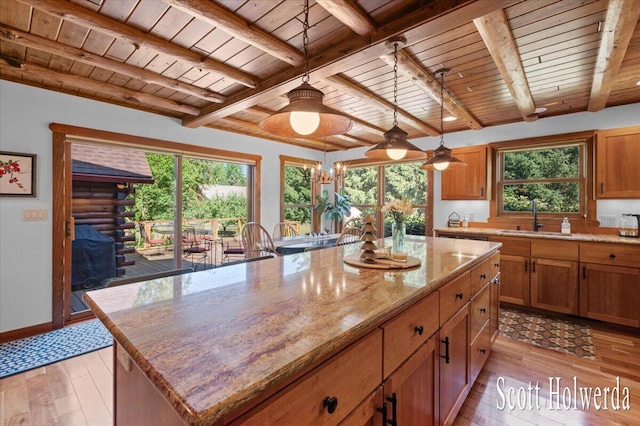 6311 142nd Ave, Holland, MI 49423 - kitchen with a wooden ceiling with exposed beams, light wood-style floors, brown cabinetry, and healthy amount of natural light