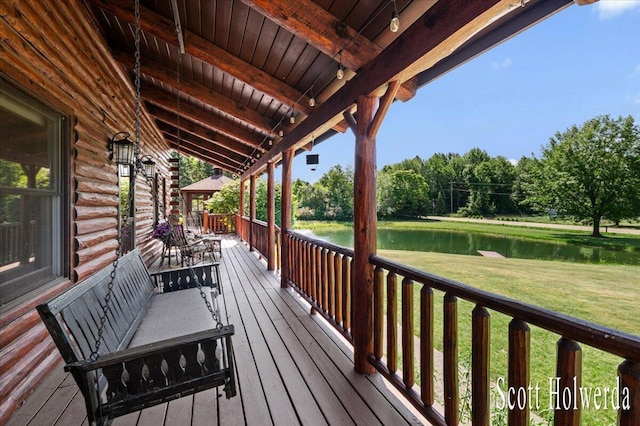 6311 142nd Ave, Holland, MI 49423 - wooden terrace with a water view, a yard, and view of scattered trees
