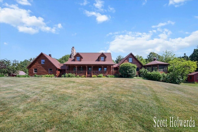 6311 142nd Ave, Holland, MI 49423 - view of front facade with a front lawn, covered porch, and a chimney