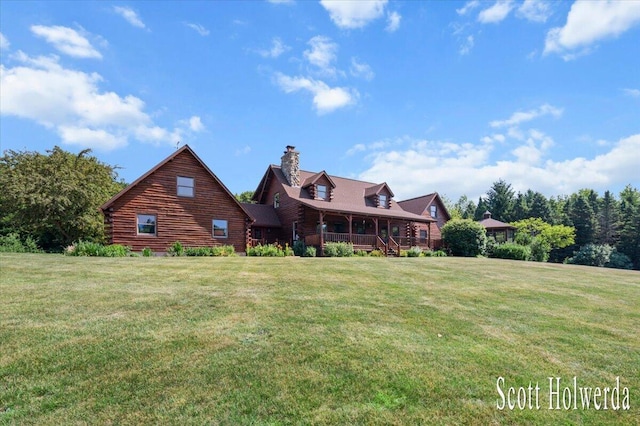 6311 142nd Ave, Holland, MI 49423 - rear view of house featuring log exterior, a chimney, covered porch, and a lawn