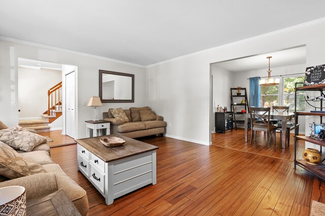 7154 Sandpiper St, Portage, MI 49024 - living room featuring ornamental molding, dark wood-style floors, and stairs