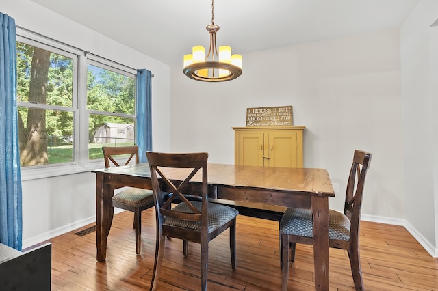 7154 Sandpiper St, Portage, MI 49024 - dining room with a chandelier, healthy amount of natural light, and light wood-style floors