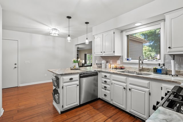 7154 Sandpiper St, Portage, MI 49024 - kitchen featuring appliances with stainless steel finishes, a peninsula, white cabinetry, and decorative backsplash