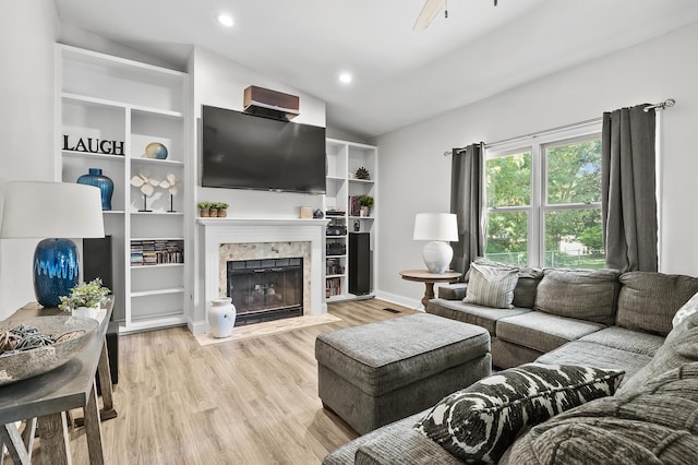 7154 Sandpiper St, Portage, MI 49024 - living room featuring vaulted ceiling, wood finished floors, a high end fireplace, ceiling fan, and recessed lighting
