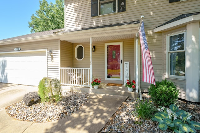 7154 Sandpiper St, Portage, MI 49024 - view of exterior entry featuring covered porch, a garage, and concrete driveway