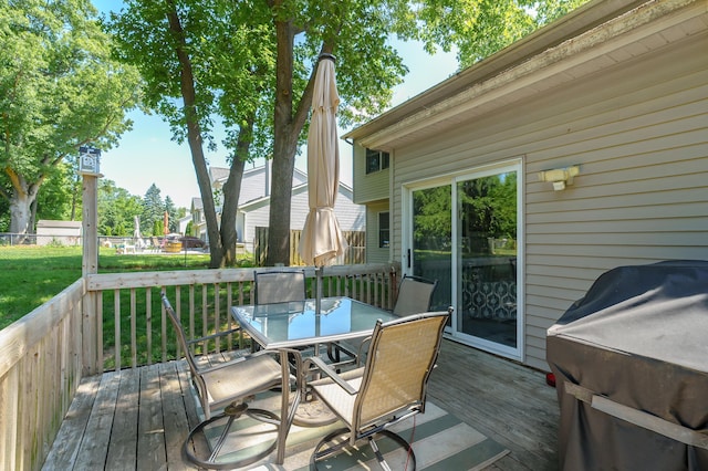 7154 Sandpiper St, Portage, MI 49024 - wooden deck featuring outdoor dining space, a lawn, and grilling area