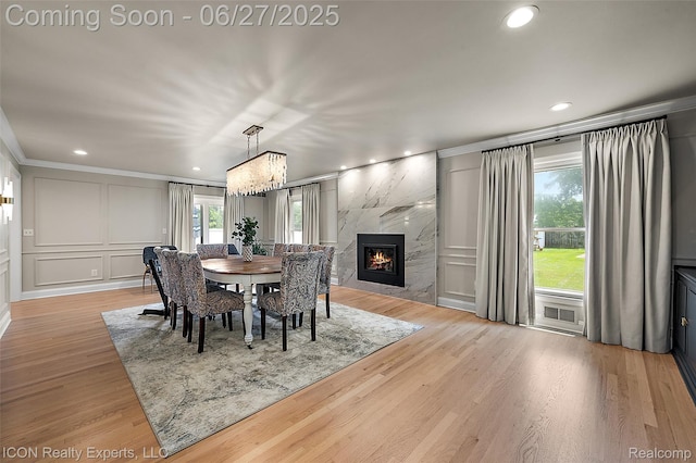 28440 Brooks Ln, Southfield, MI 48034 - dining room with healthy amount of natural light, crown molding, a decorative wall, recessed lighting, and light wood-type flooring