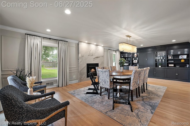 28440 Brooks Ln, Southfield, MI 48034 - dining room with crown molding, recessed lighting, light wood-style flooring, and a high end fireplace