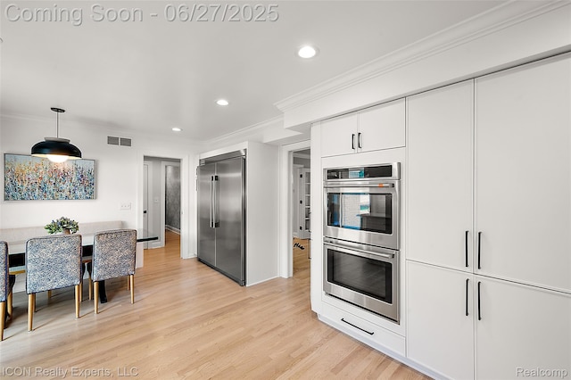 28440 Brooks Ln, Southfield, MI 48034 - kitchen with appliances with stainless steel finishes, recessed lighting, crown molding, light wood-type flooring, and white cabinetry