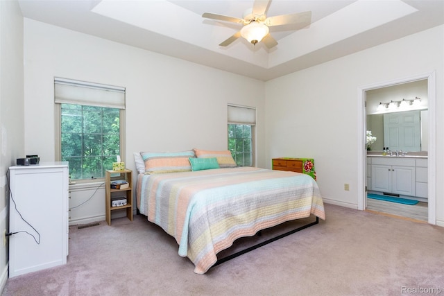 10267 Coachman Ct, Davison, MI 48423 - bedroom with light colored carpet, multiple windows, and connected bathroom