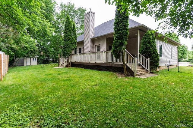 10267 Coachman Ct, Davison, MI 48423 - rear view of house with a chimney, a wooden deck, and roof with shingles