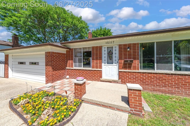 15117 Adams Ave, Warren, MI 48088 - single story home featuring a garage, brick siding, driveway, and a chimney