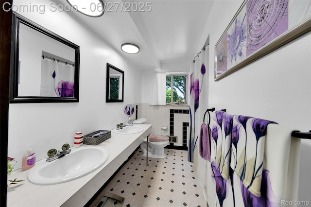 15117 Adams Ave, Warren, MI 48088 - full bathroom with tile walls, double vanity, a wainscoted wall, tile patterned floors, and a shower with shower curtain