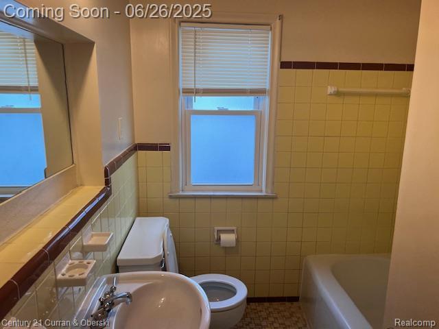 7548 Rockdale, Redford, MI 48239 - bathroom with tile walls, a tub to relax in, and wainscoting
